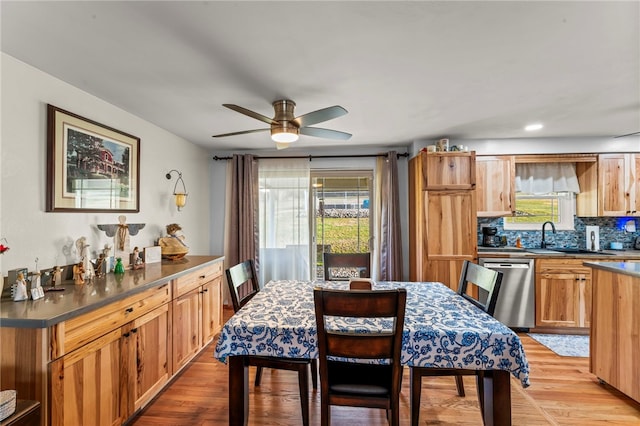 dining room featuring light wood finished floors and a ceiling fan