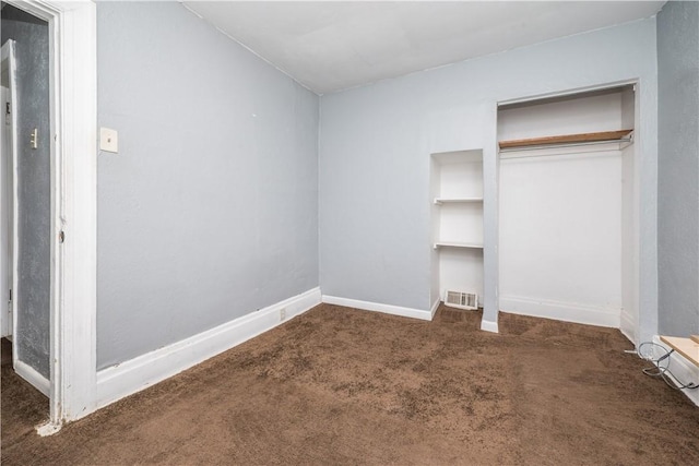 unfurnished bedroom featuring a closet, visible vents, baseboards, and carpet floors