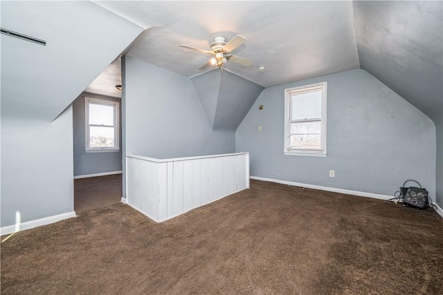 bonus room with plenty of natural light, carpet flooring, and ceiling fan