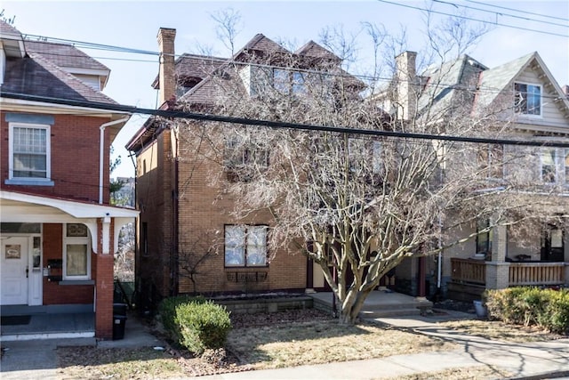 view of front of house with brick siding and a porch