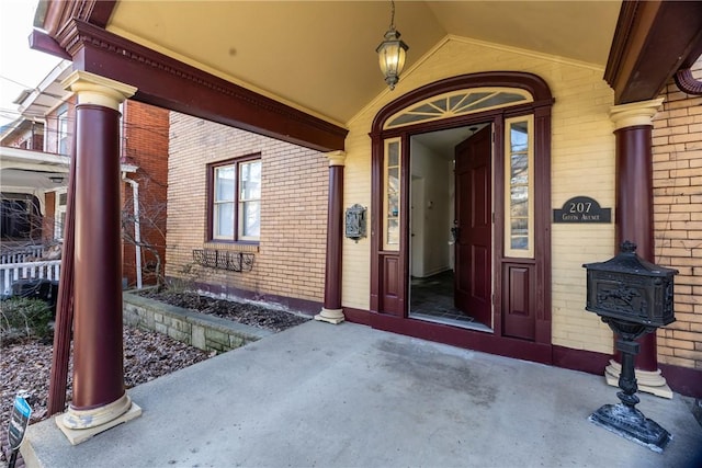 view of exterior entry with brick siding