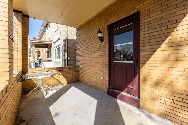 doorway to property featuring brick siding