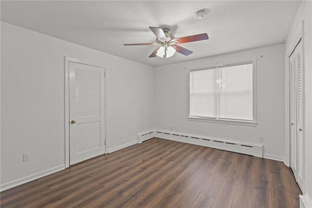 unfurnished bedroom with baseboard heating, a ceiling fan, baseboards, and wood finished floors