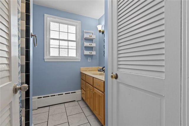 bathroom featuring baseboards, baseboard heating, marble finish floor, and vanity