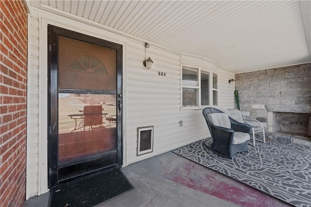 view of exterior entry featuring covered porch