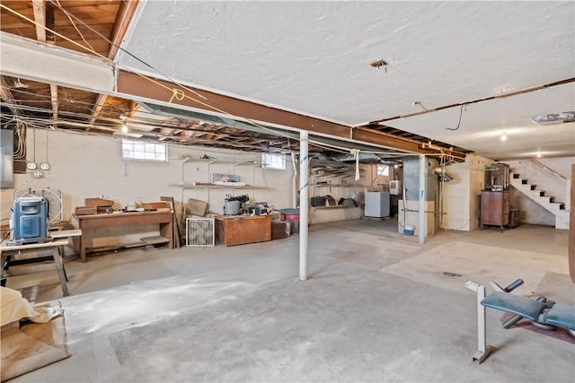 below grade area featuring stairs, washer / clothes dryer, and electric panel