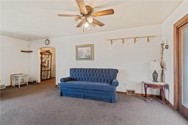 sitting room with carpet, arched walkways, visible vents, and ceiling fan