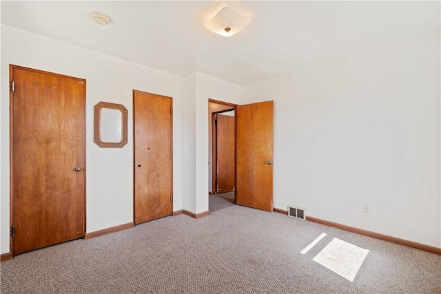 unfurnished bedroom with visible vents, baseboards, and carpet floors