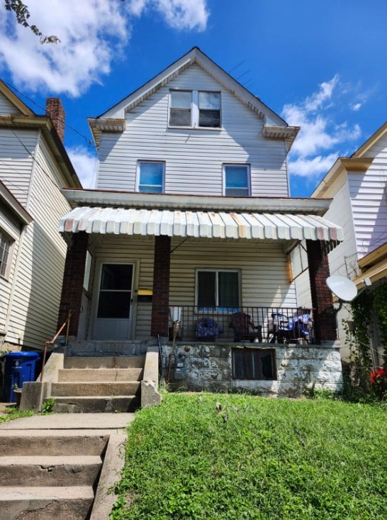 rear view of property with a porch