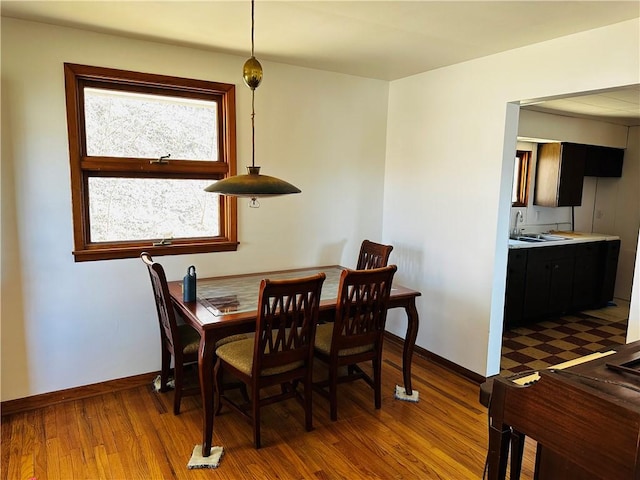 dining area with wood finished floors and baseboards