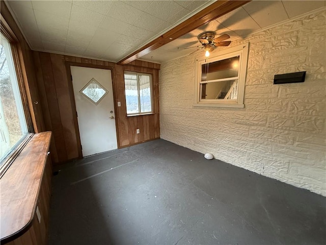 interior space with finished concrete flooring and ceiling fan