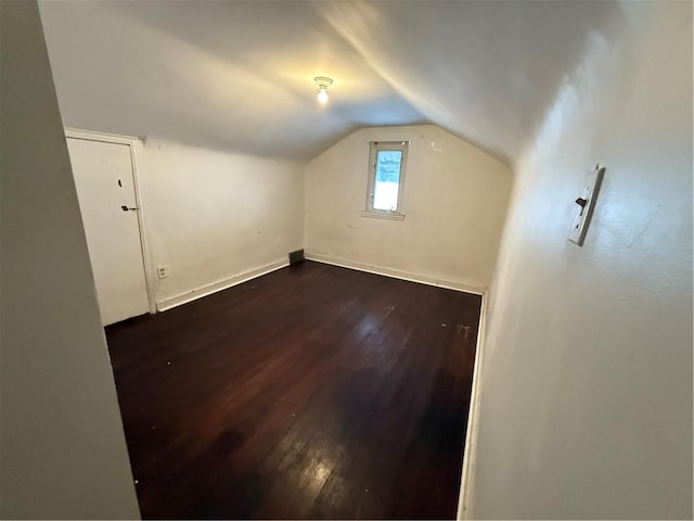 bonus room with baseboards, dark wood-type flooring, and lofted ceiling