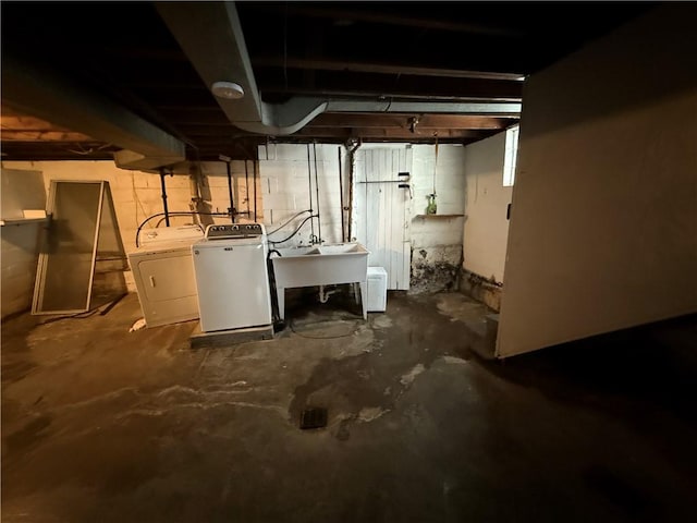 unfinished basement with separate washer and dryer and a sink