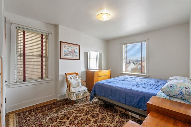 bedroom featuring baseboards and wood finished floors