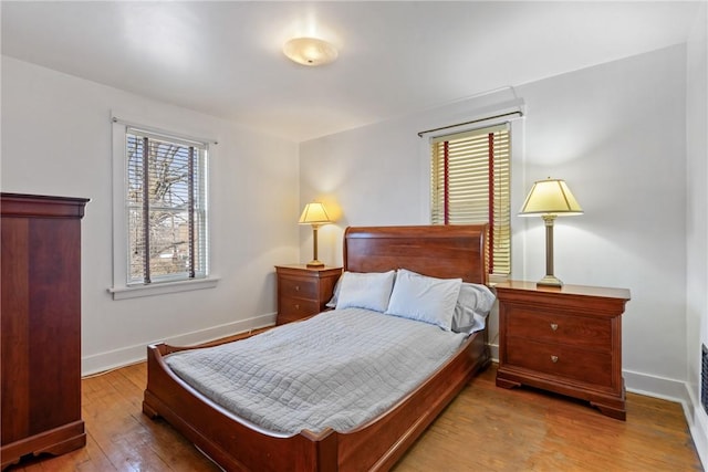 bedroom with baseboards and wood-type flooring