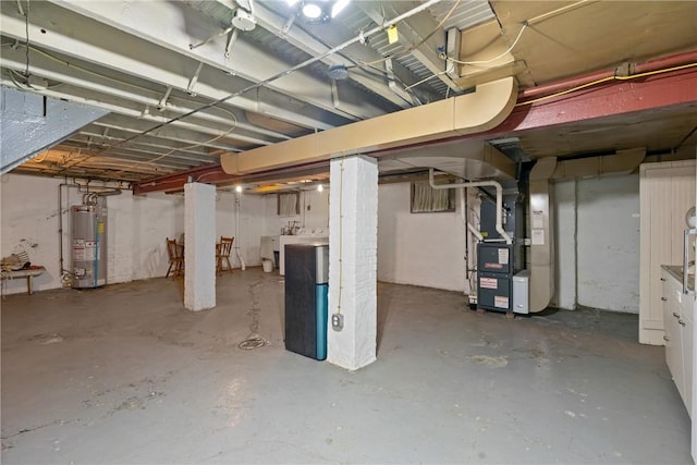 unfinished basement featuring gas water heater and heating unit