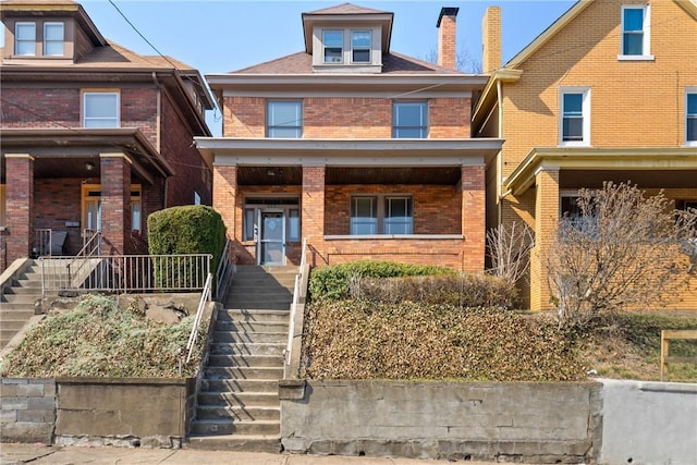 view of front facade featuring stairs, a porch, and brick siding