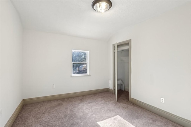 unfurnished bedroom featuring a closet, baseboards, and carpet flooring