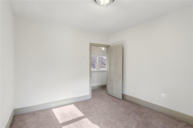 spare room with carpet flooring and baseboards