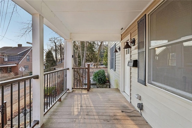 wooden terrace featuring covered porch