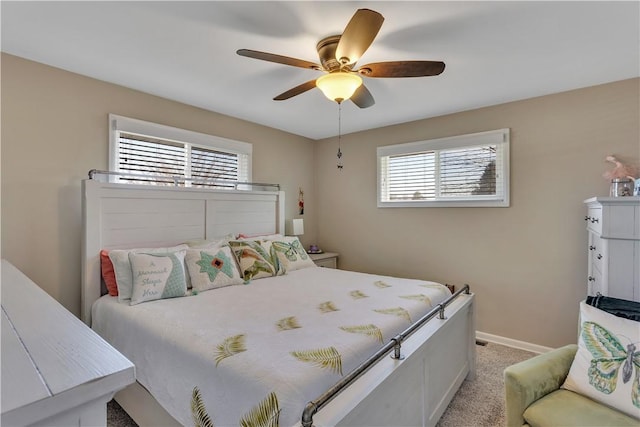 bedroom featuring light carpet, a ceiling fan, and baseboards