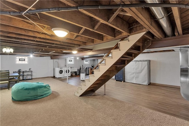 below grade area with wood finished floors, stairway, separate washer and dryer, and a sink