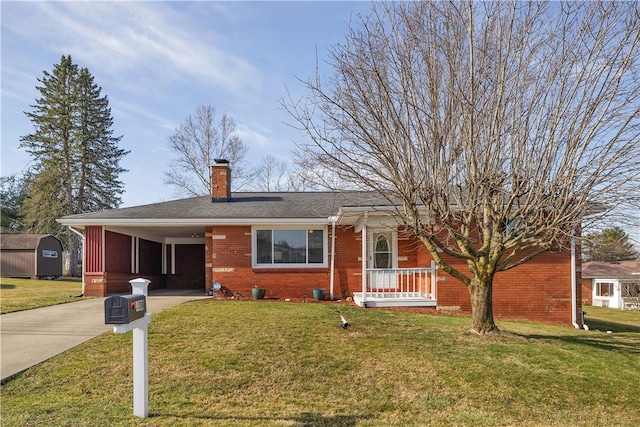 single story home with brick siding, an attached carport, concrete driveway, a front yard, and a chimney