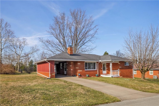 ranch-style home featuring a carport, concrete driveway, brick siding, and a front lawn