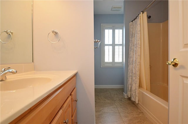 bathroom with vanity, baseboards, visible vents, shower / bath combination with curtain, and tile patterned floors