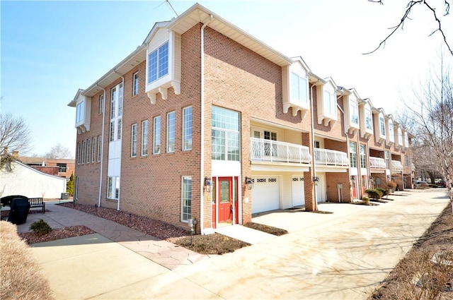 view of property featuring a residential view, driveway, and an attached garage