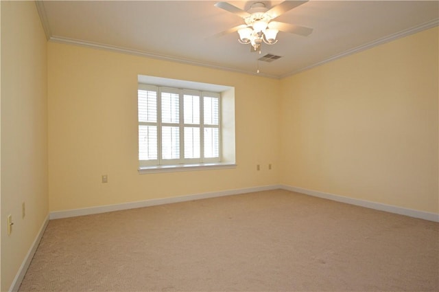 empty room featuring visible vents, baseboards, ceiling fan, crown molding, and light colored carpet