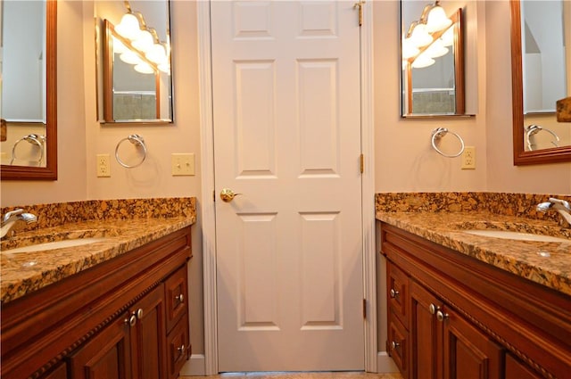 full bathroom featuring a sink and two vanities