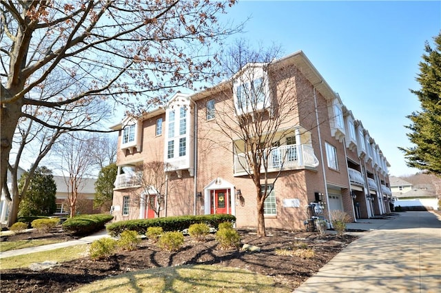 view of property featuring an attached garage and driveway