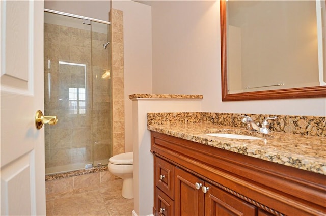 full bathroom featuring vanity, toilet, and a stall shower