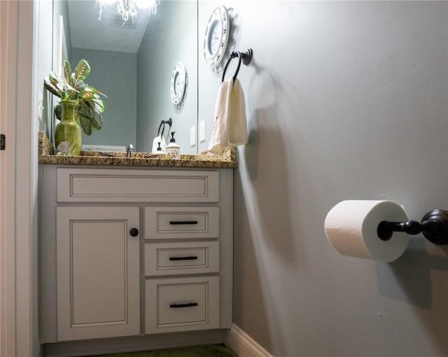 bathroom featuring baseboards and vanity