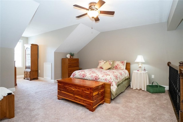 bedroom with baseboards, light colored carpet, ceiling fan, and vaulted ceiling