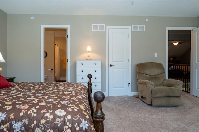 bedroom with ensuite bath, carpet, and visible vents