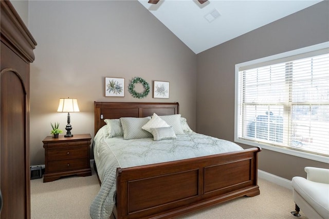 bedroom featuring visible vents, baseboards, ceiling fan, vaulted ceiling, and light colored carpet