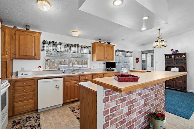 kitchen with dishwasher, light countertops, electric stove, and a sink