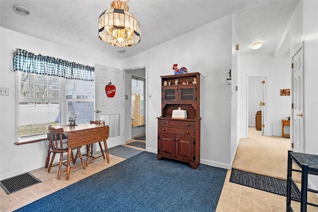 foyer with visible vents, baseboards, an inviting chandelier, and tile patterned flooring