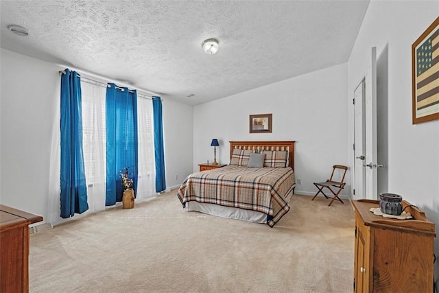 carpeted bedroom featuring a textured ceiling