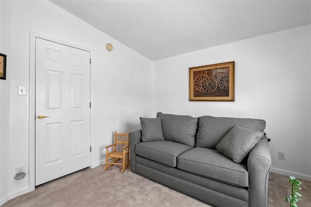 carpeted living area featuring baseboards