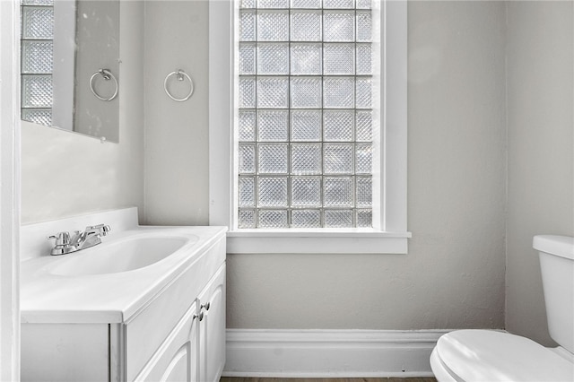 bathroom featuring toilet and vanity