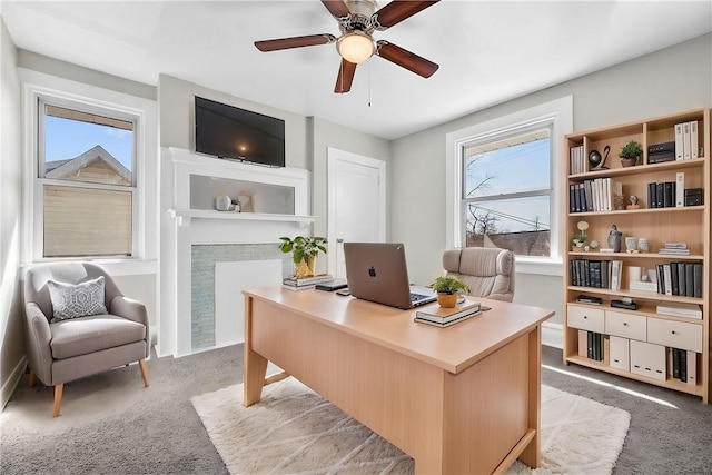 home office featuring light colored carpet and ceiling fan