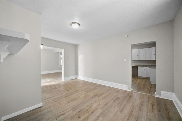 unfurnished living room featuring light wood-style floors and baseboards