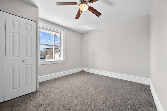 unfurnished room featuring baseboards, carpet, and a ceiling fan