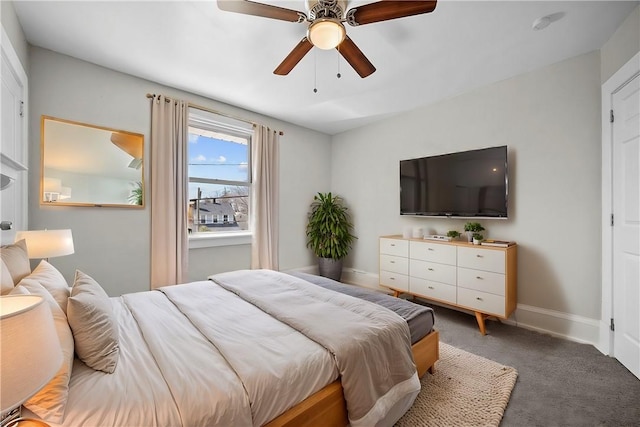 carpeted bedroom featuring ceiling fan and baseboards