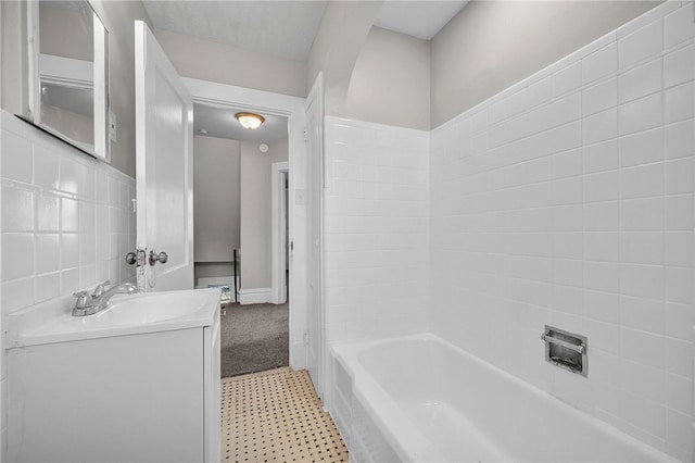 bathroom with shower / tub combination, tile walls, and vanity