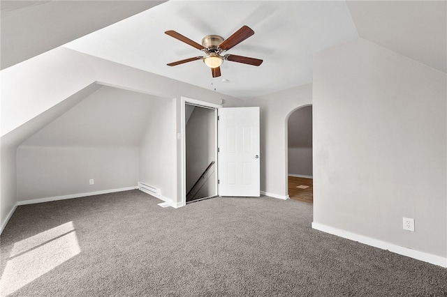 bonus room with a ceiling fan, arched walkways, carpet, baseboards, and vaulted ceiling