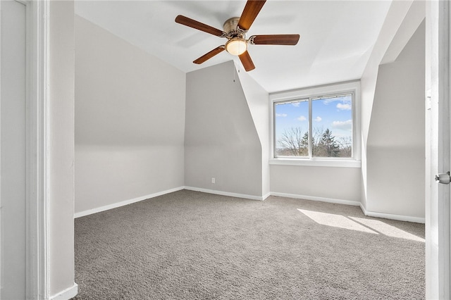 additional living space featuring carpet flooring, baseboards, a ceiling fan, and vaulted ceiling